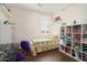 Bedroom with hardwood flooring, shelving and plenty of natural light at 16876 W Stevenage St, Surprise, AZ 85374
