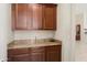 Butlers pantry with granite countertops and custom cabinets at 16876 W Stevenage St, Surprise, AZ 85374