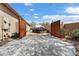 Long driveway with wooden gates providing ample space for parking and privacy at 16876 W Stevenage St, Surprise, AZ 85374