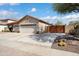 Beautiful home featuring a spacious driveway, two-car garage, desert landscaping, and an inviting exterior at 16876 W Stevenage St, Surprise, AZ 85374