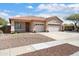 Charming single-story home with a three-car garage and well-maintained desert landscaping at 16876 W Stevenage St, Surprise, AZ 85374