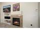 Close up shot of the living room fireplace area with built-in shelves and entertainment features at 16876 W Stevenage St, Surprise, AZ 85374