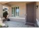 Inviting front porch featuring a secure screen door and tile flooring at 16876 W Stevenage St, Surprise, AZ 85374