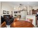 Open concept living room with tile floors, fireplace, ceiling fan and decorative lighting at 16876 W Stevenage St, Surprise, AZ 85374