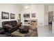 Inviting living room features a cozy fireplace, comfortable seating, and bright recessed lighting at 16876 W Stevenage St, Surprise, AZ 85374