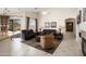 Spacious living room with fireplace, tile floors, and sliding doors to the outdoor living space at 16876 W Stevenage St, Surprise, AZ 85374