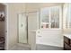 Spa-like main bathroom with walk-in shower and soaking tub by a bright window at 16876 W Stevenage St, Surprise, AZ 85374