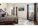 Spacious main bedroom featuring a ceiling fan, ensuite bathroom, and access to the outdoor living area at 16876 W Stevenage St, Surprise, AZ 85374