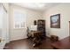 Cozy office space featuring a wooden desk, rolling chair, and plantation shutters at 16876 W Stevenage St, Surprise, AZ 85374