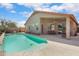 The backyard features a private pool, covered patio, and desert plants creating a tranquil oasis at 16876 W Stevenage St, Surprise, AZ 85374