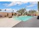 A refreshing pool with desert landscaping, surrounded by a privacy wall and comfortable lounge seating at 16876 W Stevenage St, Surprise, AZ 85374