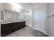 This bathroom boasts a double sink vanity, a walk-in shower, and modern fixtures at 18007 W Camino De Oro --, Surprise, AZ 85387