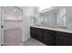 The bathroom features a double vanity sink with granite countertops and wood-look flooring at 18007 W Camino De Oro --, Surprise, AZ 85387