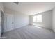 This bedroom features a window and door, providing both light and accessibility at 18007 W Camino De Oro --, Surprise, AZ 85387