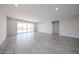 Spacious living room featuring wood-look tile flooring, recessed lighting, and sliding glass doors to the outdoor space at 18007 W Camino De Oro --, Surprise, AZ 85387