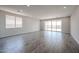 Bright and airy living room featuring wood-look tile flooring, recessed lighting, and large windows for natural light at 18007 W Camino De Oro --, Surprise, AZ 85387