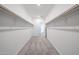 Spacious walk-in closet with rod and shelf storage and gray carpeting at 18007 W Camino De Oro --, Surprise, AZ 85387