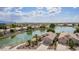 Stunning waterfront home with lush landscaping and tranquil lake views in a vibrant community at 1806 N 108Th Ave, Avondale, AZ 85392