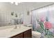 Charming bathroom with a stylish vanity, a well lit mirror, and a unique cactus-themed shower curtain at 1806 N 108Th Ave, Avondale, AZ 85392