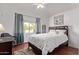 Serene bedroom featuring a queen size bed, a ceiling fan, and a window with natural light at 1806 N 108Th Ave, Avondale, AZ 85392