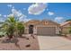 Charming home featuring desert landscaping, a spacious two-car garage, and a welcoming facade at 1806 N 108Th Ave, Avondale, AZ 85392