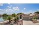 Inviting single-story home with a well-manicured front yard and beautiful lake view at 1806 N 108Th Ave, Avondale, AZ 85392