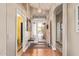 Elegant foyer with hardwood floors, an arched doorway, and an ornate pendant light fixture at 1806 N 108Th Ave, Avondale, AZ 85392