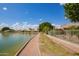 Picturesque lakeside community featuring a walking path, lush landscaping, and serene water views for relaxation and enjoyment at 1806 N 108Th Ave, Avondale, AZ 85392