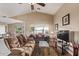 Comfortable living room featuring vaulted ceilings, lots of seating and bright, airy windows at 1806 N 108Th Ave, Avondale, AZ 85392
