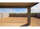 Covered patio overlooking a low maintenance backyard with block wall at 18171 W Daley Ln, Surprise, AZ 85387