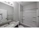 This bathroom features a granite-look vanity, and a shower over tub with a shower curtain and built-in shelves at 18171 W Daley Ln, Surprise, AZ 85387