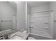The bathroom is efficiently designed with a granite-look vanity, toilet, and shower over tub with built-in shelves at 18171 W Daley Ln, Surprise, AZ 85387