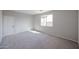 Bedroom with a neutral color scheme, large window, and plush carpeting at 18171 W Daley Ln, Surprise, AZ 85387
