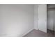 A modern bedroom with neutral carpet, gray walls, and a closet with white door at 18171 W Daley Ln, Surprise, AZ 85387
