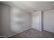 This bedroom provides neutral carpet and walls, and a closet creating a serene retreat at 18171 W Daley Ln, Surprise, AZ 85387