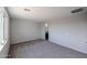 Spacious bedroom with plush carpeting, natural light, and an ensuite bathroom at 18171 W Daley Ln, Surprise, AZ 85387
