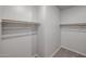 Walk-in closet featuring rods for organized hanging and easy storage at 18171 W Daley Ln, Surprise, AZ 85387