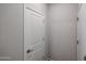 White paneled closet door with silver hardware and grey wall at 18171 W Daley Ln, Surprise, AZ 85387