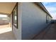 Exterior side view of home with covered patio, stucco and windows at 18171 W Daley Ln, Surprise, AZ 85387