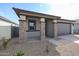 Single-story home boasting stone pillar accents and desert landscaping at 18171 W Daley Ln, Surprise, AZ 85387