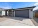 A single story home showcasing a two-car garage and desert landscaping at 18171 W Daley Ln, Surprise, AZ 85387