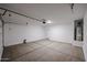 Clean, empty garage with a water heater, ready for a car and other storage at 18171 W Daley Ln, Surprise, AZ 85387