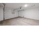 Spacious two-car garage with automatic door and concrete flooring, ready for storage at 18171 W Daley Ln, Surprise, AZ 85387