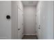 Bright hallway featuring neutral paint, a thermostat, and doors at 18171 W Daley Ln, Surprise, AZ 85387