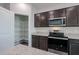 Modern kitchen features stainless steel appliances, granite counters, and a walk-in pantry at 18171 W Daley Ln, Surprise, AZ 85387