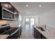 Modern kitchen with stainless steel appliances, granite countertops and a large island at 18171 W Daley Ln, Surprise, AZ 85387
