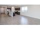 Open-concept kitchen boasts granite countertops, stainless appliances, and a large island at 18171 W Daley Ln, Surprise, AZ 85387