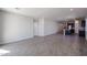 Bright, open-concept living room with tiled floors leading to the kitchen at 18171 W Daley Ln, Surprise, AZ 85387