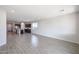 Bright open-concept living room featuring a tile floors leading to the kitchen at 18171 W Daley Ln, Surprise, AZ 85387