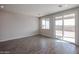 Sunlit open-concept living space with tile flooring and sliding door to the backyard at 18171 W Daley Ln, Surprise, AZ 85387